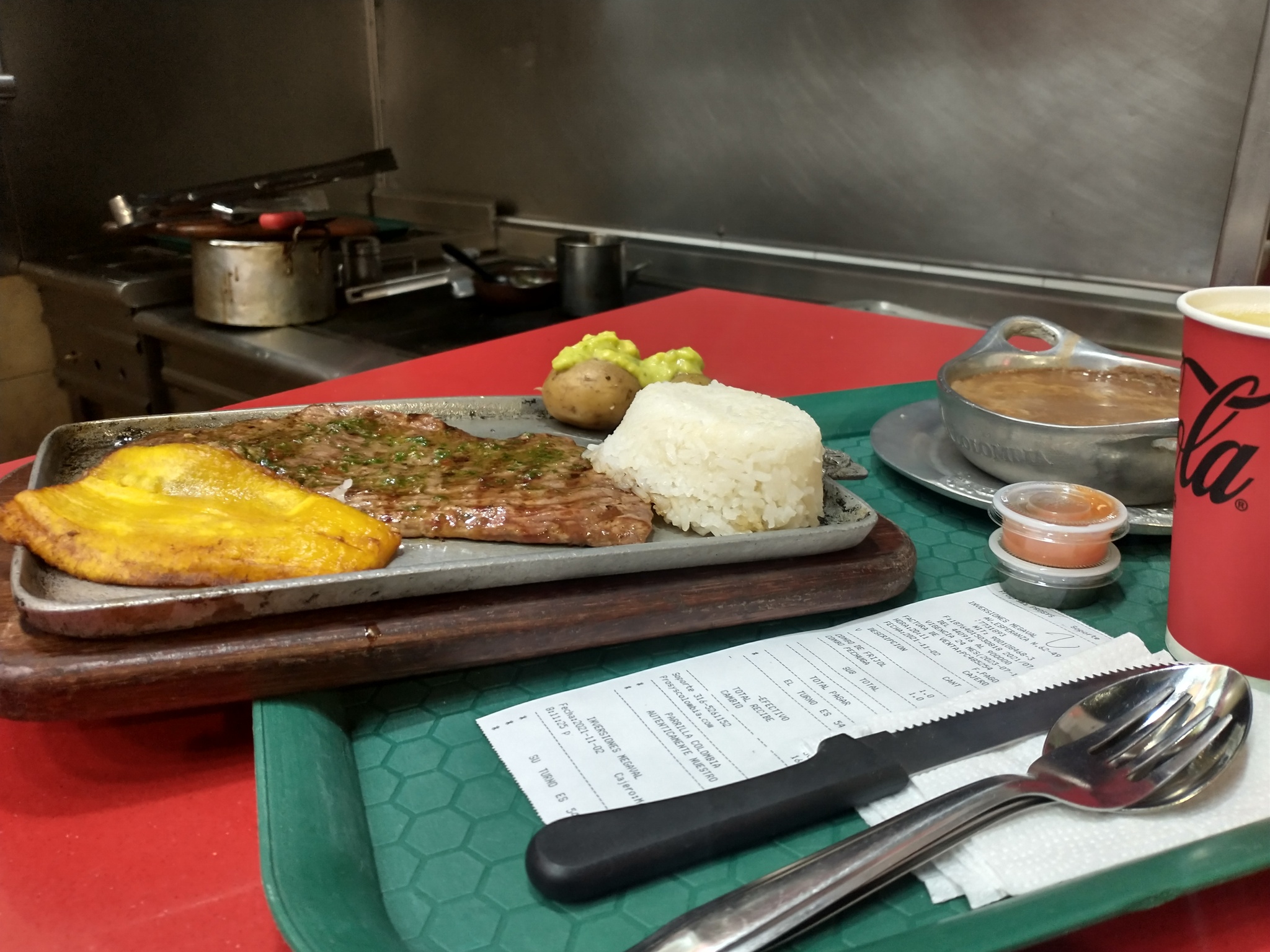 Steak meal with white rice, potato, and pinto beans.